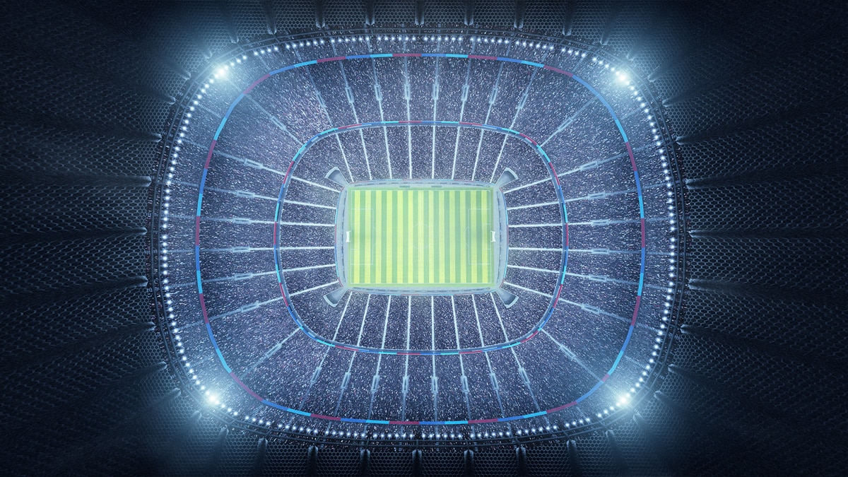 Looking down on lit up football stadium at night